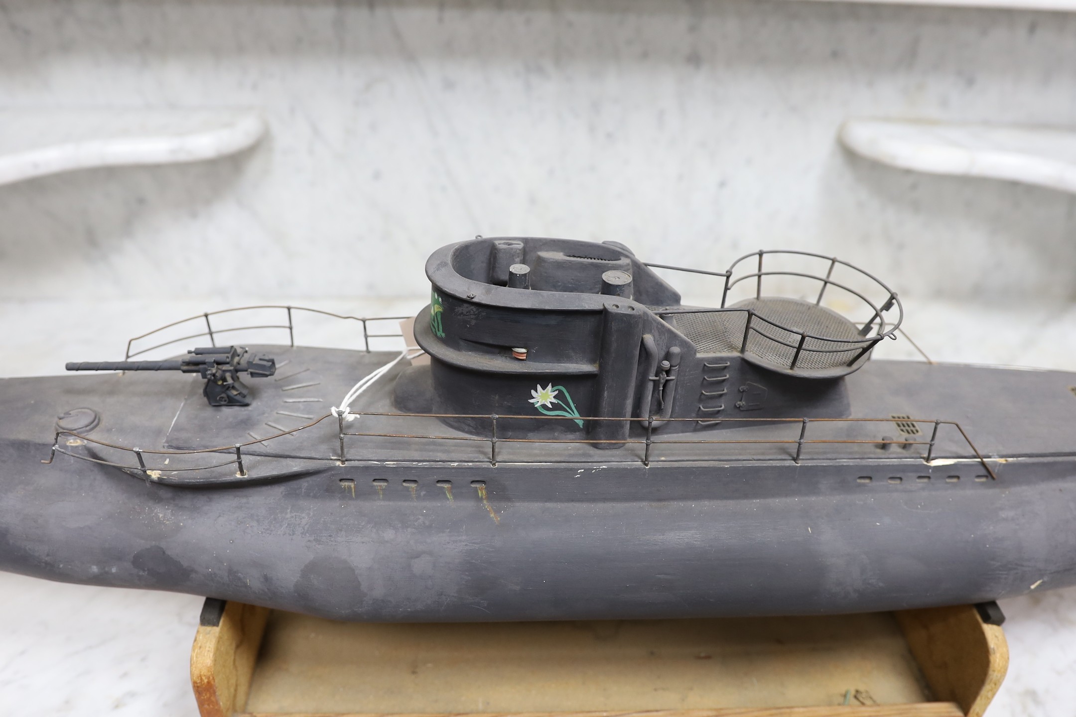 A painted wood model of a German U boat, 170 cms long